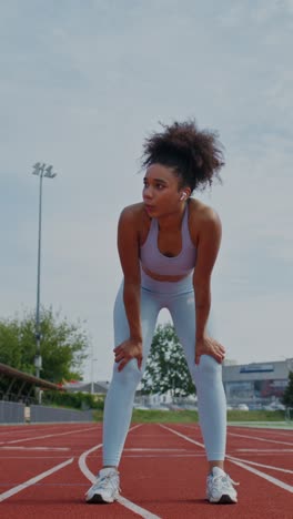 woman stretching on running track