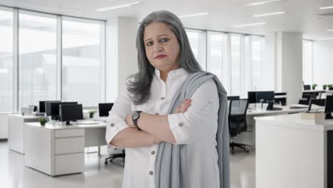 portrait of confident indian senior businesswoman standing crossed hands