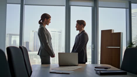 two professionals in a business meeting in a modern office