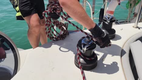 sailor handling lines on a yacht deck