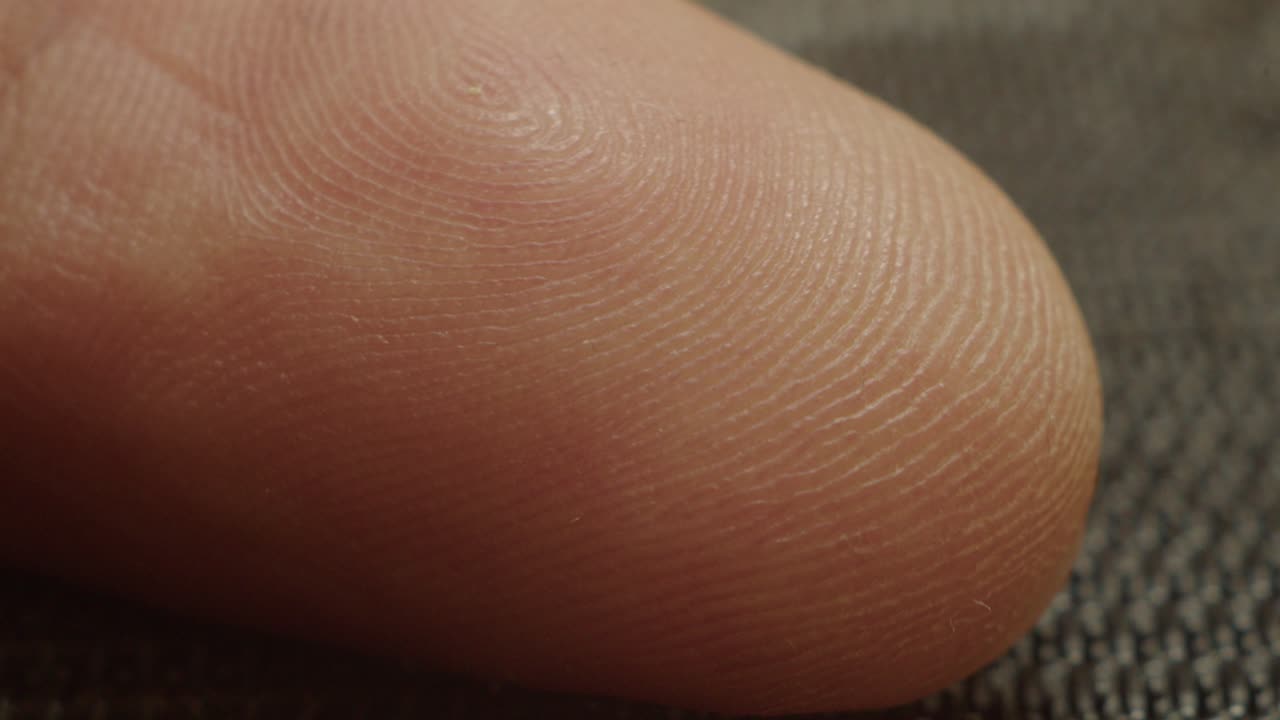 Ultra-close macro of a human finger showing unique skin patterns and fine lines. Ideal for medical, design, or texture-based visuals