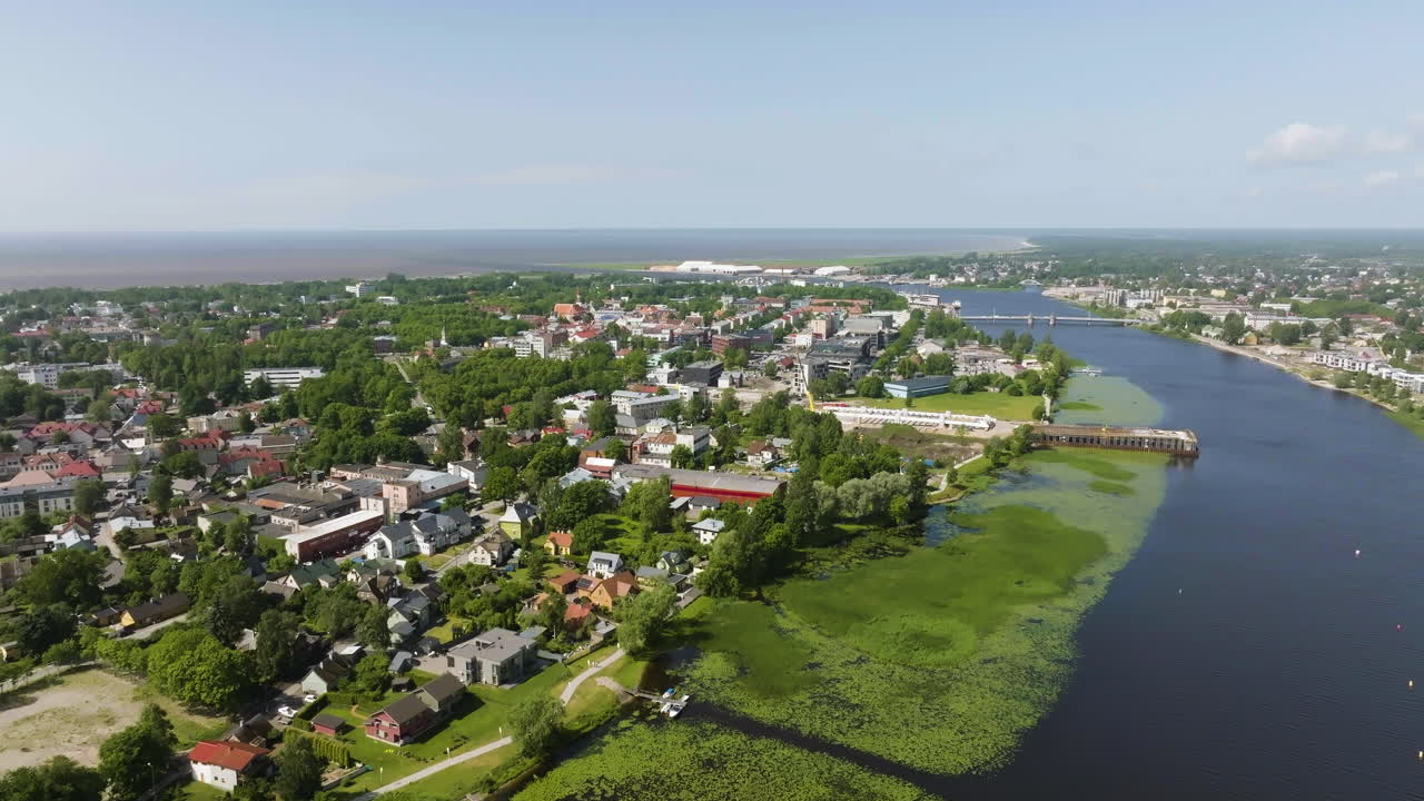 Panoramic drone shot of the riverside of Parnu city, sunny, summer day in Estonia