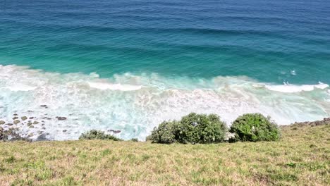 aerial view of waves hitting a rocky coast