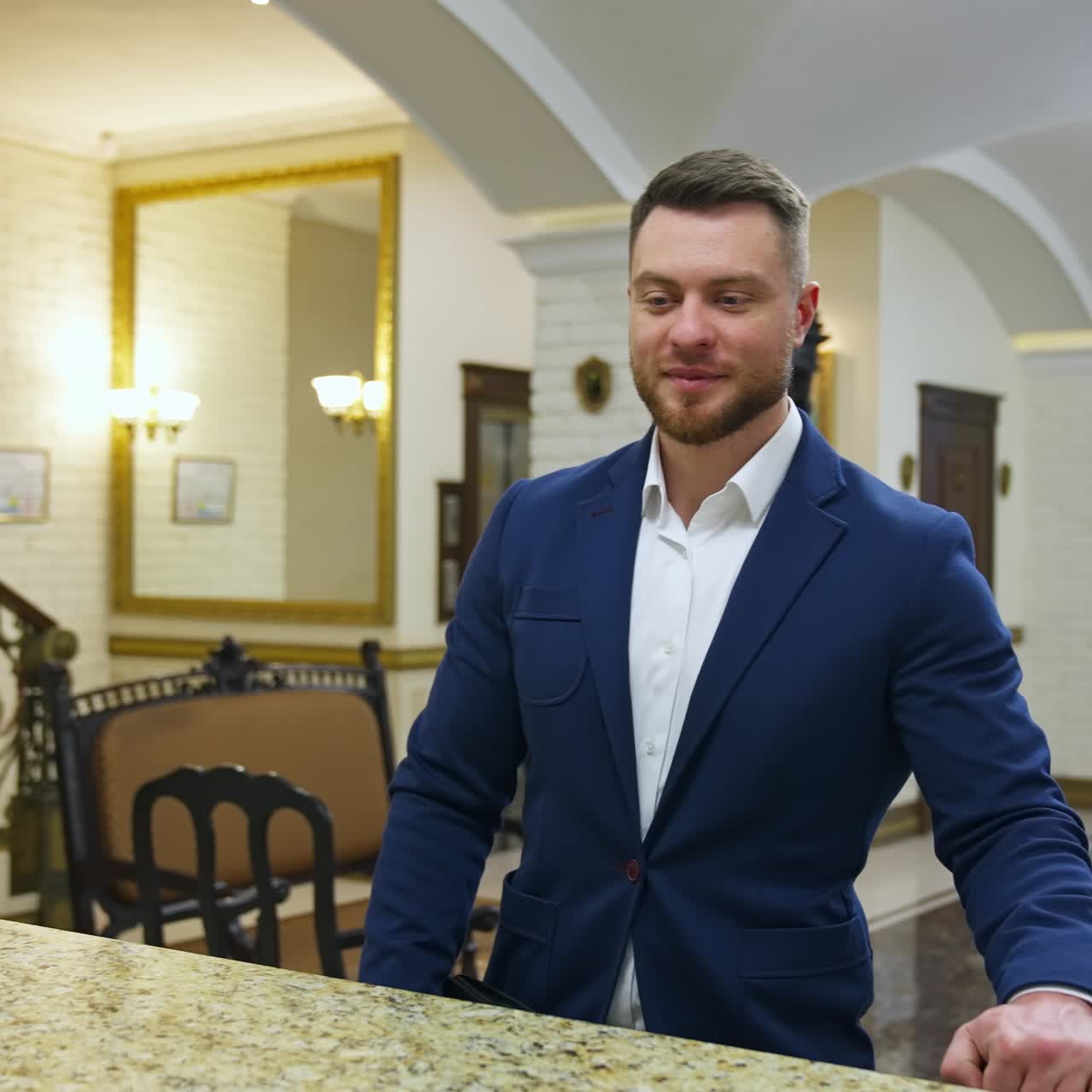Businessman at reception of hotel. Young businessman at modern hotel reception