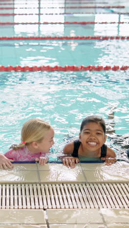 two girls having fun in a swimming pool