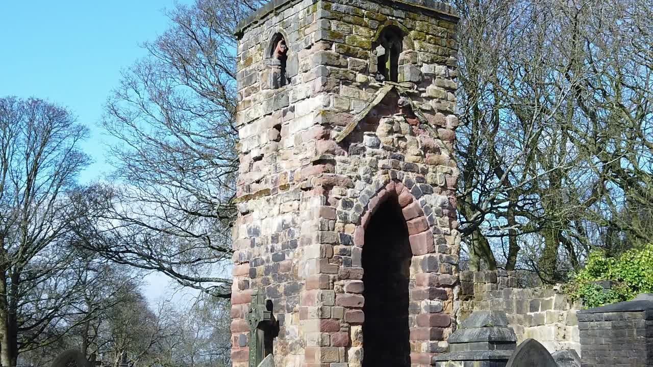 역사적인 windleshaw chantry masonry 타워 외관은 푸른 하늘을 배경으로 폐허를 둘러싼 느린 움직임