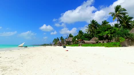 a-dream-beach-with-flat-sand-and-turquoise-waters-with-coconut-palms-and-a-local-fishing-boat