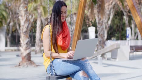 Trendy-young-student-working-in-an-urban-park