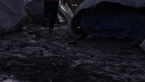 refugee walks within muddy conditions moria refugee camp