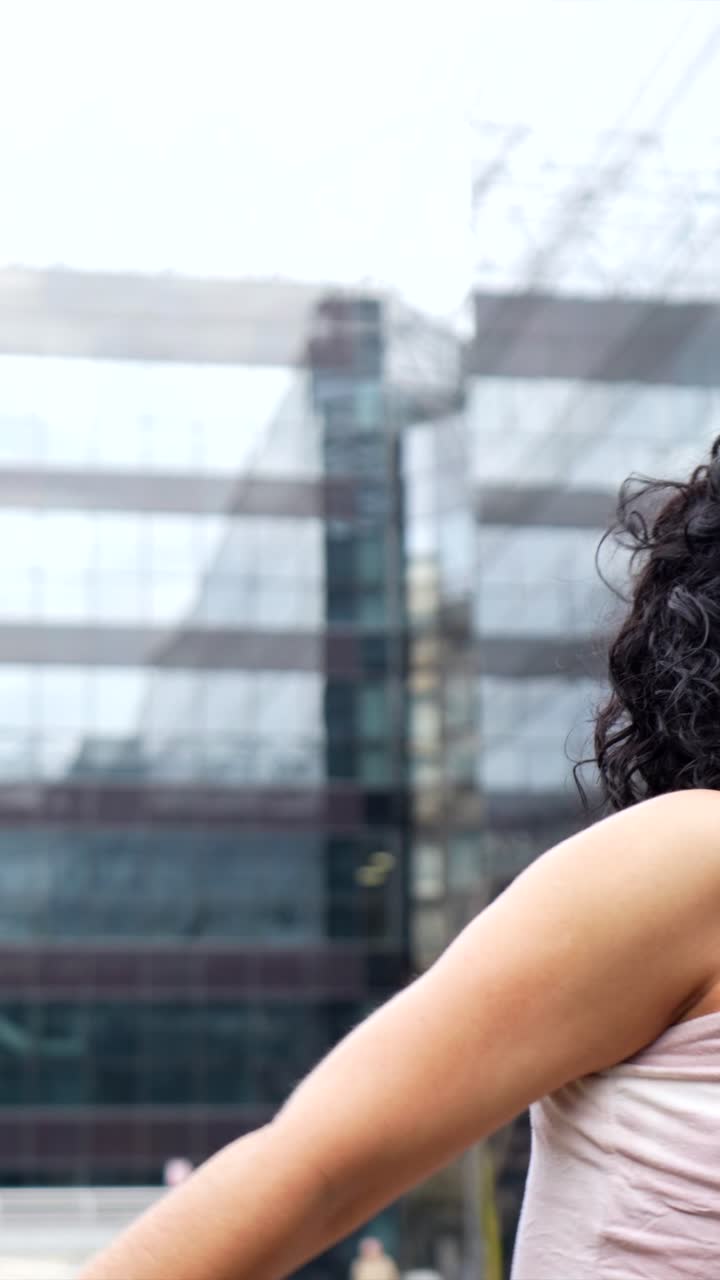 Woman with curly hair in an urban setting