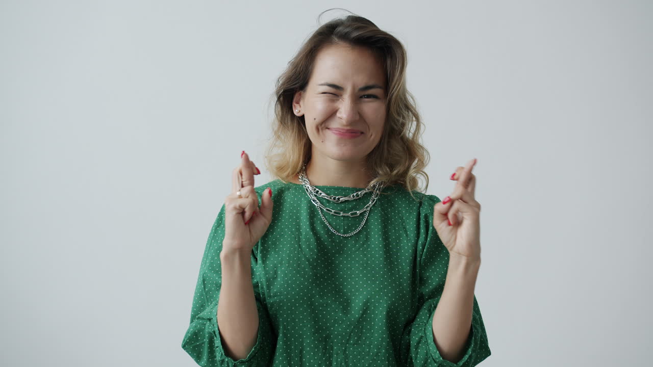 Woman Celebrating Success in Green Polka Dot Dress