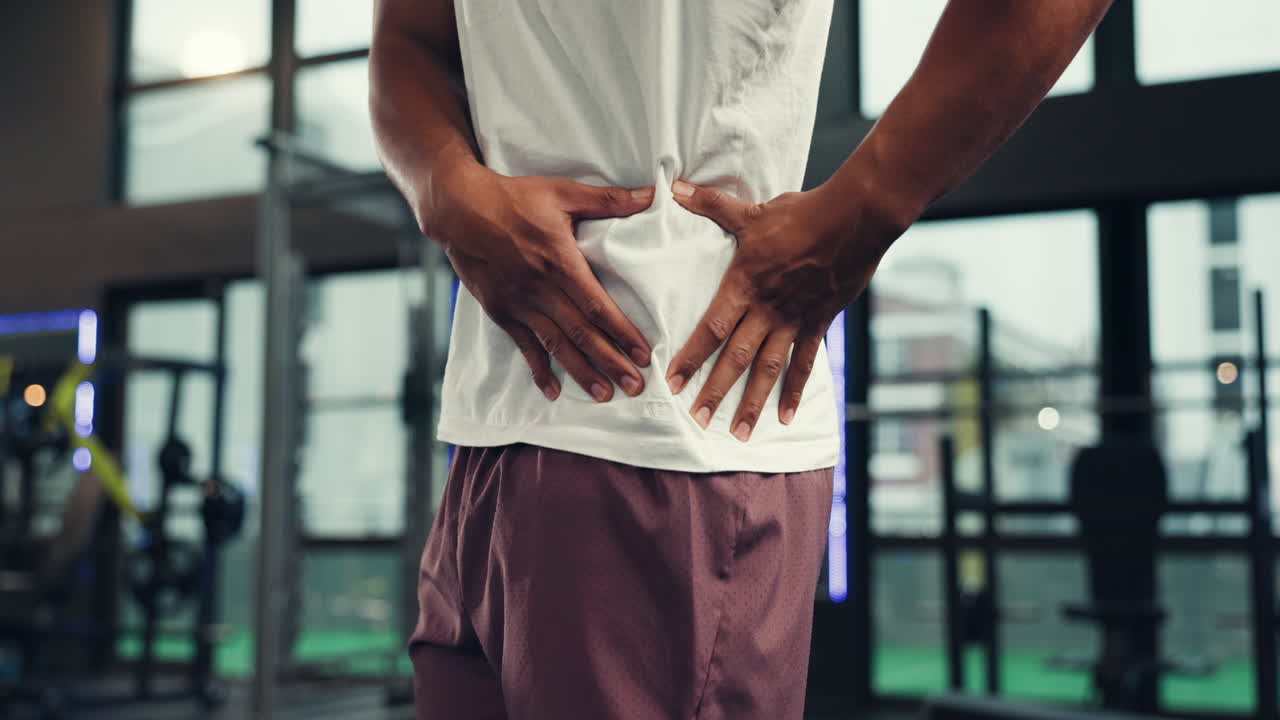 Man experiencing back pain after workout