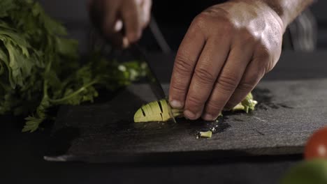 fresh avocado being chopped on black board, healthy food theme