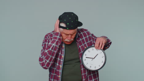 confused senior man with anxiety checking time on clock running late to work being in delay deadline