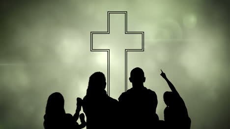 animation of silhouette of christian cross and a family over glowing green clouds