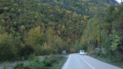 van driving through the fall colors all around slovenia's durmitor national park