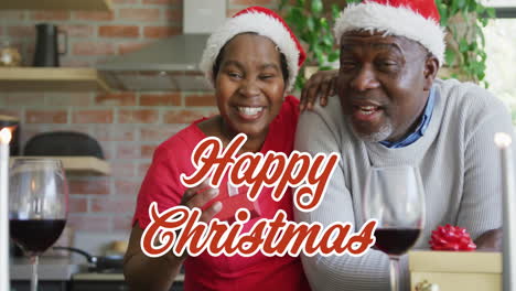 animation of christmas greetings text over african american couple in santa hats at christmas