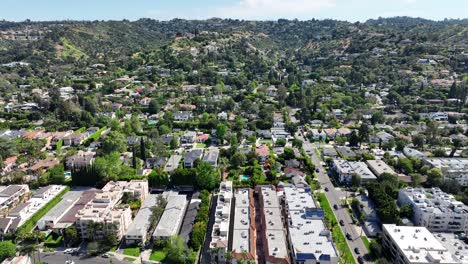 drone shot of sherman oaks neighborhood, buildings, street traffic and hills