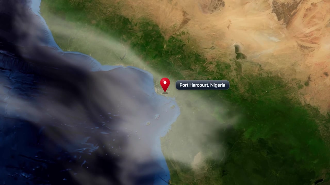 Satellite view zooms from outer space directly down to Port Harcourt, Nigeria with pinpoint marker. Includes NASA public domain imagery.