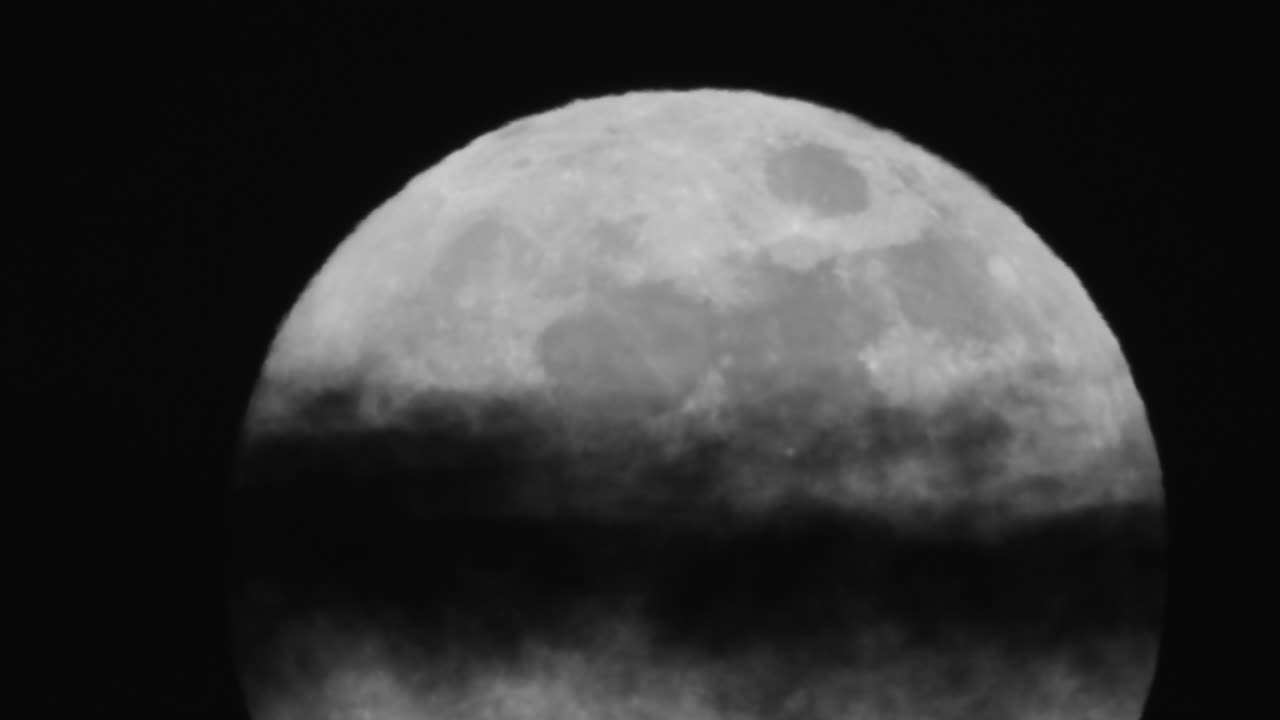 Close up of the moon with a cloud going through it. Shot in Reserve Faunique Laverendrye Natural Reserve in Canada