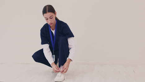 hospital, nurse and woman tie shoes ready