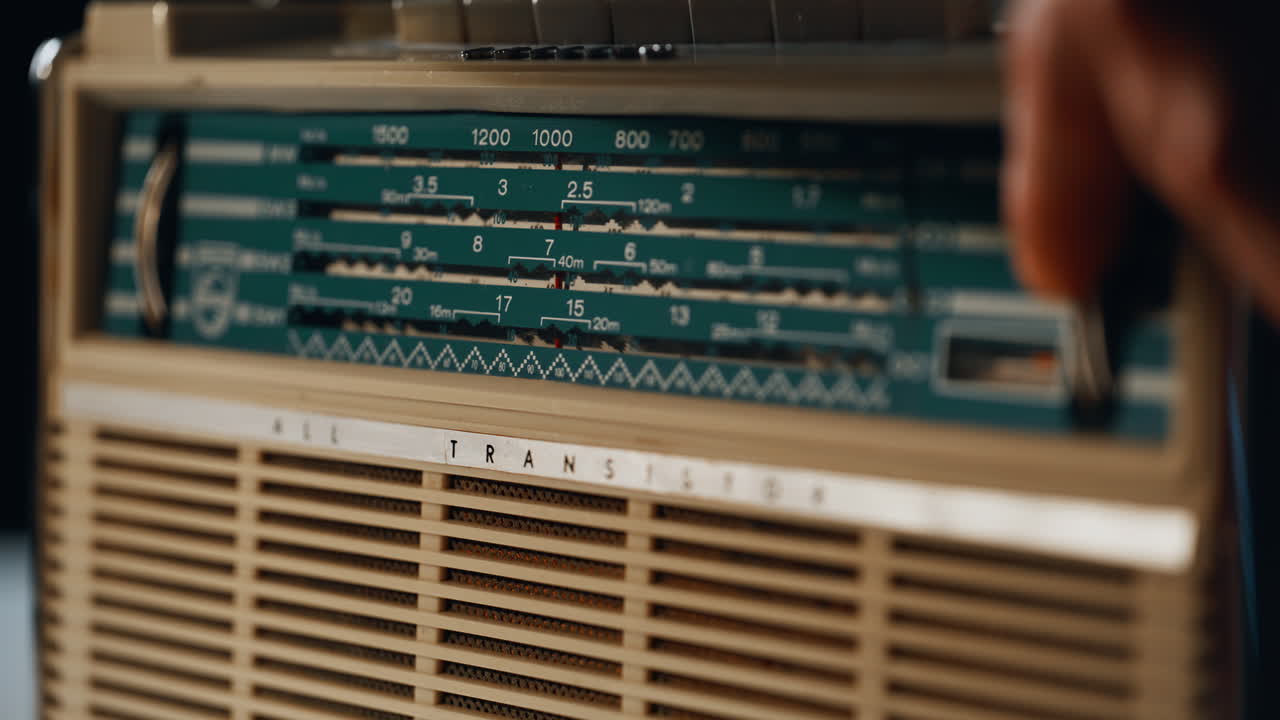 Classic radio box standing table playing music closeup. Macro view man hand