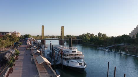 rising aerial shot of the delta king steamboat on the sacramento river