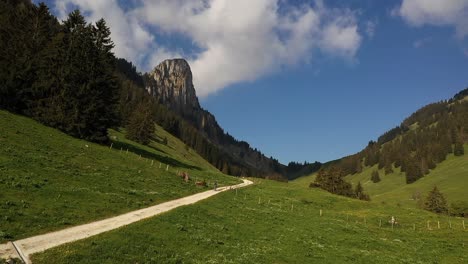 aerial, drone shot backpacking trekking alone on mountain valley