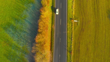 drone flight over open country road with some traffic