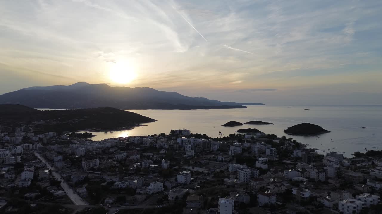 Sunset over Coastal Town with Mountains and Sea