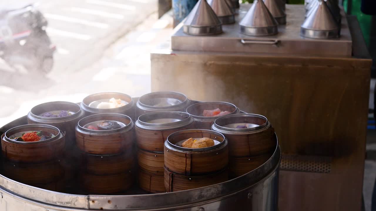 A rotating tray of steaming dim sum baskets in a vibrant street market setting, highlighting traditional Asian cuisine