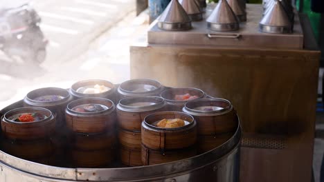 a rotating tray of steaming dim sum baskets in a vibrant street market setting, highlighting traditional asian cuisine