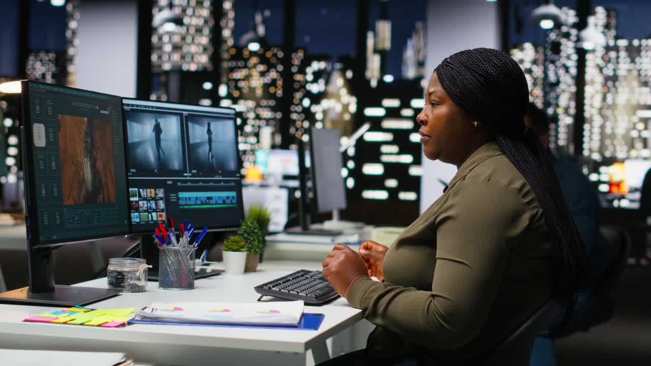 Diverse colleagues working together on video editing for a montage on software