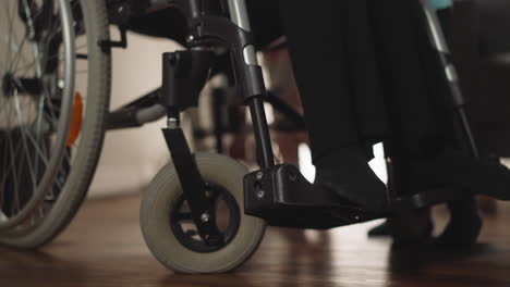 legs of woman with spinal cord injury sitting in wheelchair