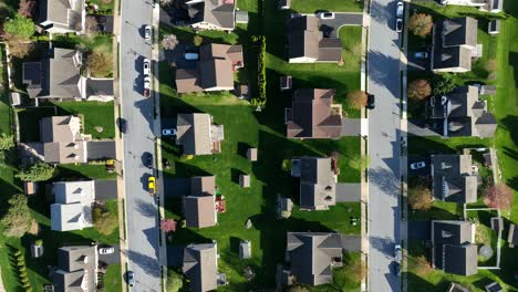 Quaint-American-Neighborhood-with-parking-cars-on-street-and-green-garden-in-spring