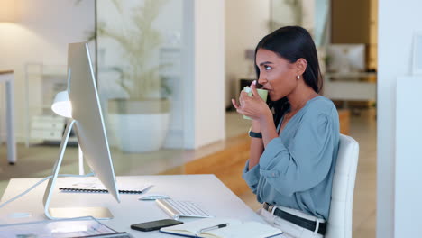 female executive reading and typing an email to