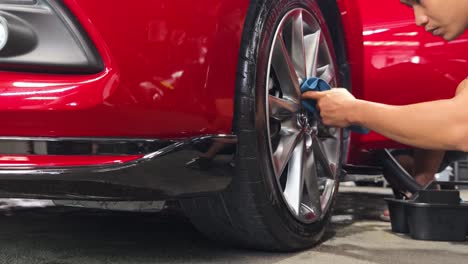 red car wheel cleaning and detailing