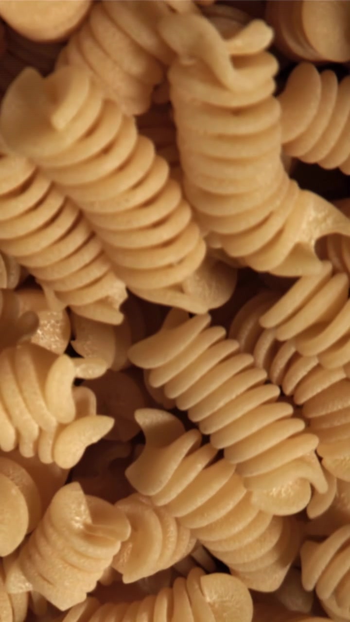 Close-up View of Dry Uncooked Spiral Fusilli Pasta