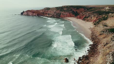 coastal landscape with waves and red cliffs