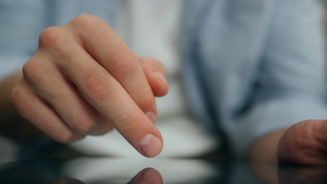 man fingers typing tablet screen indoors close up. unknown guy texting new tab