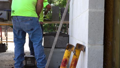 men building a masonry pillar