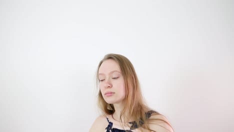 Beautiful Young Woman in a Dress Posing in a Studio