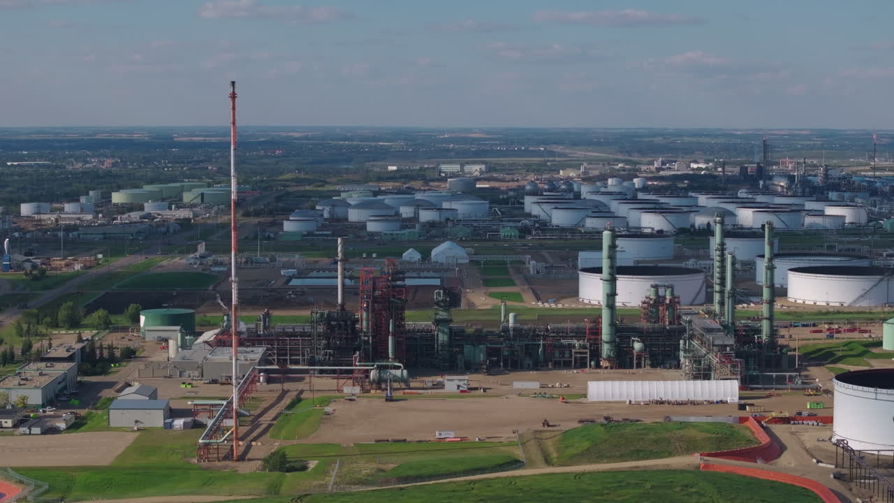 Wide aerial of an industrial refinery on a clear day, expansive view