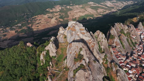 aerial drone of pietrapertosa, italy—mountain village built into rocky peaks, terracotta roofs, sweeping valley views. ideal for travel, tourism, culture, and cinematic landscape stock footage