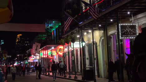 establishing shot of bourbon street in new orleans at night