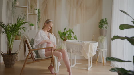 pregnant woman posing in decorated baby room