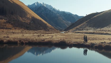 couple dancing lakeside in rural mountain location