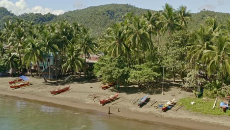 Smooth-aerial-dolly-view-along-the-beach-of-Bacuag,-a-popular-tourist-beach-in-Surigao-Del-Norte-Philippines