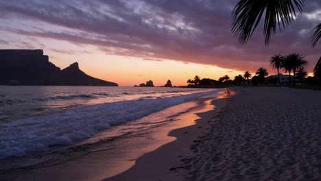 Sunset on a tropical beach with mountains