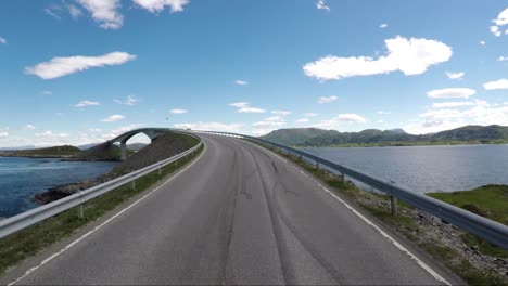 driving a car on a road in norway atlantic ocean road or the atlantic road (atlanterhavsveien) been awarded the title as (norwegian construction of the century).